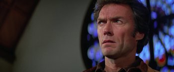 Movie still from “The Enforcer” (1976), directed by James Fargo – A person looking up at something; Close Up shot, Low angle