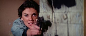 Movie still from “The Enforcer” (1976), directed by James Fargo – A woman holding a gun in her hand; Close Up shot, Low angle