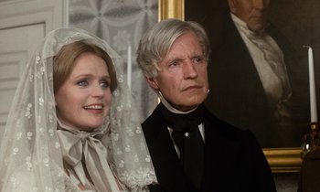 Movie still from “The Europeans” (1979), directed by James Ivory – A man and a woman standing next to each other in front of a curtain; Close Up shot, Over the shoulder angle