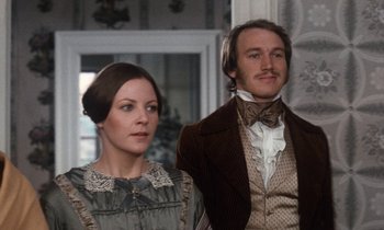 Movie still from “The Europeans” (1979), directed by James Ivory – A man and a woman standing next to each other; Medium shot, Low angle