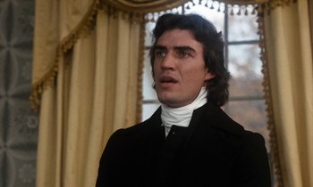 Movie still from “The Europeans” (1979), directed by James Ivory – A man with long hair wearing a black coat; Close Up shot, Low angle