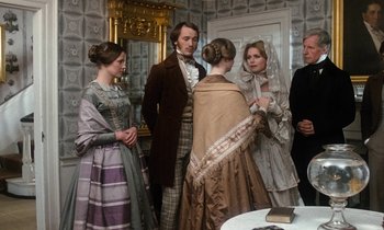 Movie still from “The Europeans” (1979), directed by James Ivory – A group of people standing in a room; Medium shot, Over the shoulder angle