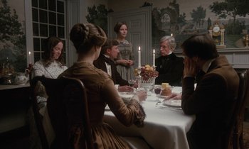 Movie still from “The Europeans” (1979), directed by James Ivory – A group of people sitting around a dinner table; Wide shot, High angle