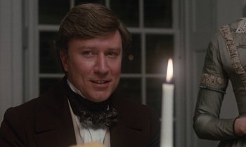 Movie still from “The Europeans” (1979), directed by James Ivory – A person wearing a suit and bow tie; Close Up shot, Over the shoulder angle