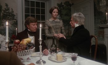 Movie still from “The Europeans” (1979), directed by James Ivory – Two men and a woman sitting at a dinner table; Medium shot, Over the shoulder angle