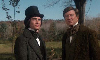Movie still from “The Europeans” (1979), directed by James Ivory – Two men dressed in period clothing standing next to each other in front of trees; Medium shot, Low angle