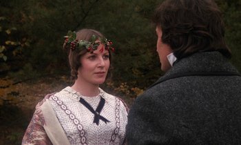 Movie still from “The Europeans” (1979), directed by James Ivory – A man and a woman wearing a wreath of holly; Close Up shot, Over the shoulder angle