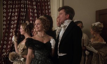 Movie still from “The Europeans” (1979), directed by James Ivory – A man and a woman dressed in formal wear; Medium shot, Low angle