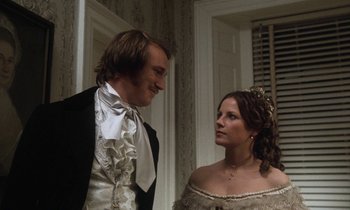 Movie still from “The Europeans” (1979), directed by James Ivory – A man and a woman standing next to each other; Medium shot, Low angle