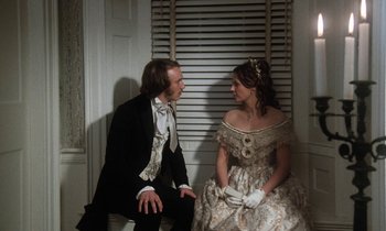 Movie still from “The Europeans” (1979), directed by James Ivory – A man and a woman dressed in formal clothing; Medium shot, Over the shoulder angle