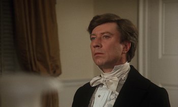 Movie still from “The Europeans” (1979), directed by James Ivory – A person wearing a suit and bow tie; Close Up shot, Low angle