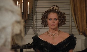 Movie still from “The Europeans” (1979), directed by James Ivory – A woman in a black dress and a tiara; Close Up shot, Over the shoulder angle