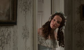 Movie still from “The Europeans” (1979), directed by James Ivory – A young woman in a dress looking into a mirror; Close Up shot, Over the shoulder angle