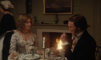 Movie still from “The Europeans” (1979), directed by James Ivory – A man and a woman sitting at a dinner table; Medium shot, Over the shoulder angle