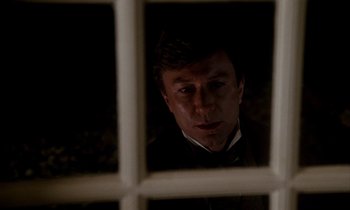 Movie still from “The Europeans” (1979), directed by James Ivory – A man looking through a window at night; Close Up shot, Over the shoulder angle