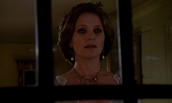 Movie still from “The Europeans” (1979), directed by James Ivory – A woman in a white dress looking into a mirror; Close Up shot, Low angle