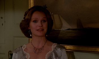 Movie still from “The Europeans” (1979), directed by James Ivory – A woman in a white dress and a necklace; Close Up shot, Low angle