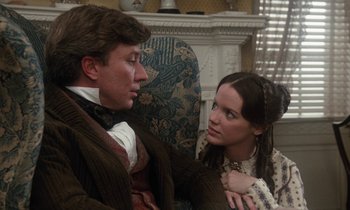Movie still from “The Europeans” (1979), directed by James Ivory – A man and a woman sitting on a couch; Medium shot, Over the shoulder angle