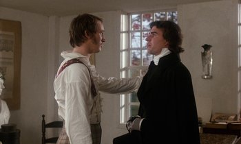 Movie still from “The Europeans” (1979), directed by James Ivory – Two men are standing in front of a window; Medium shot, Over the shoulder angle