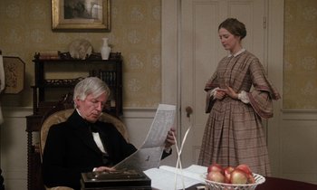 Movie still from “The Europeans” (1979), directed by James Ivory – An older man and a young woman are reading a newspaper; Medium shot, High angle
