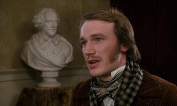 Movie still from “The Europeans” (1979), directed by James Ivory – A man with a beard and a checkered scarf; Close Up shot, Over the shoulder angle