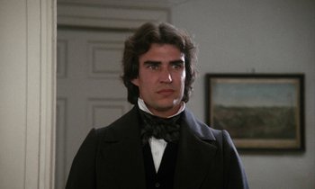 Movie still from “The Europeans” (1979), directed by James Ivory – A person wearing a suit and bow tie; Close Up shot, Over the shoulder angle