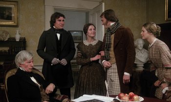 Movie still from “The Europeans” (1979), directed by James Ivory – A group of people standing around a table; Medium shot, Over the shoulder angle