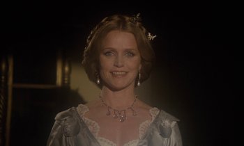 Movie still from “The Europeans” (1979), directed by James Ivory – A woman in a white dress with a butterfly necklace; Close Up shot, Low angle