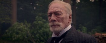Movie still from “The Exception” (2016), directed by David Leveaux – An old man with a beard and a white mustache; Close Up shot, Over the shoulder angle