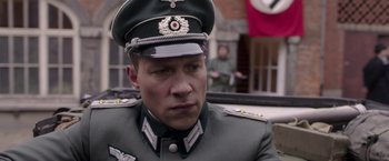 Movie still from “The Exception” (2016), directed by David Leveaux – A person wearing a military uniform; Close Up shot, Low angle