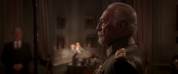 Movie still from “The Exception” (2016), directed by David Leveaux – An older man in a military uniform looking off into the distance; Close Up shot, Over the shoulder angle