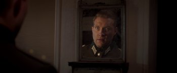 Movie still from “The Exception” (2016), directed by David Leveaux – A man in a uniform looking into a mirror; Close Up shot, Over the shoulder angle