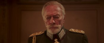 Movie still from “The Exception” (2016), directed by David Leveaux – An older man in a military uniform looking at the camera; Close Up shot, Low angle