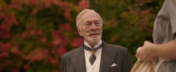 Movie still from “The Exception” (2016), directed by David Leveaux – An older man wearing a suit and tie; Close Up shot, Low angle