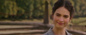 Movie still from “The Exception” (2016), directed by David Leveaux – A person smiling for the camera; Close Up shot, Over the shoulder angle