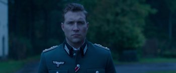 Movie still from “The Exception” (2016), directed by David Leveaux – A person wearing a uniform; Close Up shot, Low angle