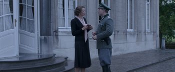 Movie still from “The Exception” (2016), directed by David Leveaux – A man and a woman talking to each other outside; Medium shot, Over the shoulder angle