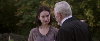 Movie still from “The Exception” (2016), directed by David Leveaux – An older man talking to a young woman outside; Close Up shot, Over the shoulder angle