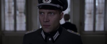 Movie still from “The Exception” (2016), directed by David Leveaux – A person wearing a uniform; Close Up shot, Low angle
