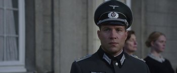 Movie still from “The Exception” (2016), directed by David Leveaux – A person wearing a uniform; Close Up shot, Low angle