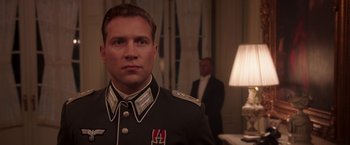 Movie still from “The Exception” (2016), directed by David Leveaux – A man in a military uniform standing in front of another man; Close Up shot, Low angle