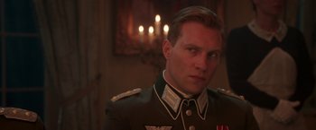Movie still from “The Exception” (2016), directed by David Leveaux – A person wearing a military uniform; Close Up shot, Low angle
