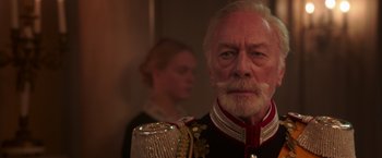 Movie still from “The Exception” (2016), directed by David Leveaux – An older man in a military uniform holding a glass; Close Up shot, Low angle