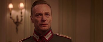 Movie still from “The Exception” (2016), directed by David Leveaux – A person wearing a military uniform; Close Up shot, Low angle