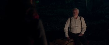 Movie still from “The Exception” (2016), directed by David Leveaux – An older man standing next to a suitcase; Medium shot, Over the shoulder angle