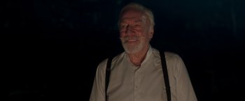 Movie still from “The Exception” (2016), directed by David Leveaux – An older man wearing suspenders and a white shirt; Close Up shot, Low angle