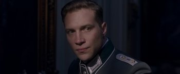 Movie still from “The Exception” (2016), directed by David Leveaux – A person wearing a uniform; Close Up shot, Over the shoulder angle