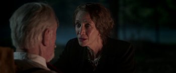 Movie still from “The Exception” (2016), directed by David Leveaux – An older woman sitting in front of a man; Close Up shot, Over the shoulder angle