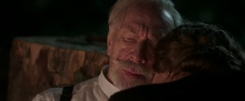 Movie still from “The Exception” (2016), directed by David Leveaux – An old man with a beard is looking down at a woman; Close Up shot, Over the shoulder angle