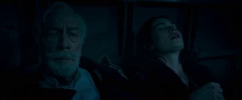 Movie still from “The Exception” (2016), directed by David Leveaux – An older man and a young woman sleeping in a car; Close Up shot, High angle